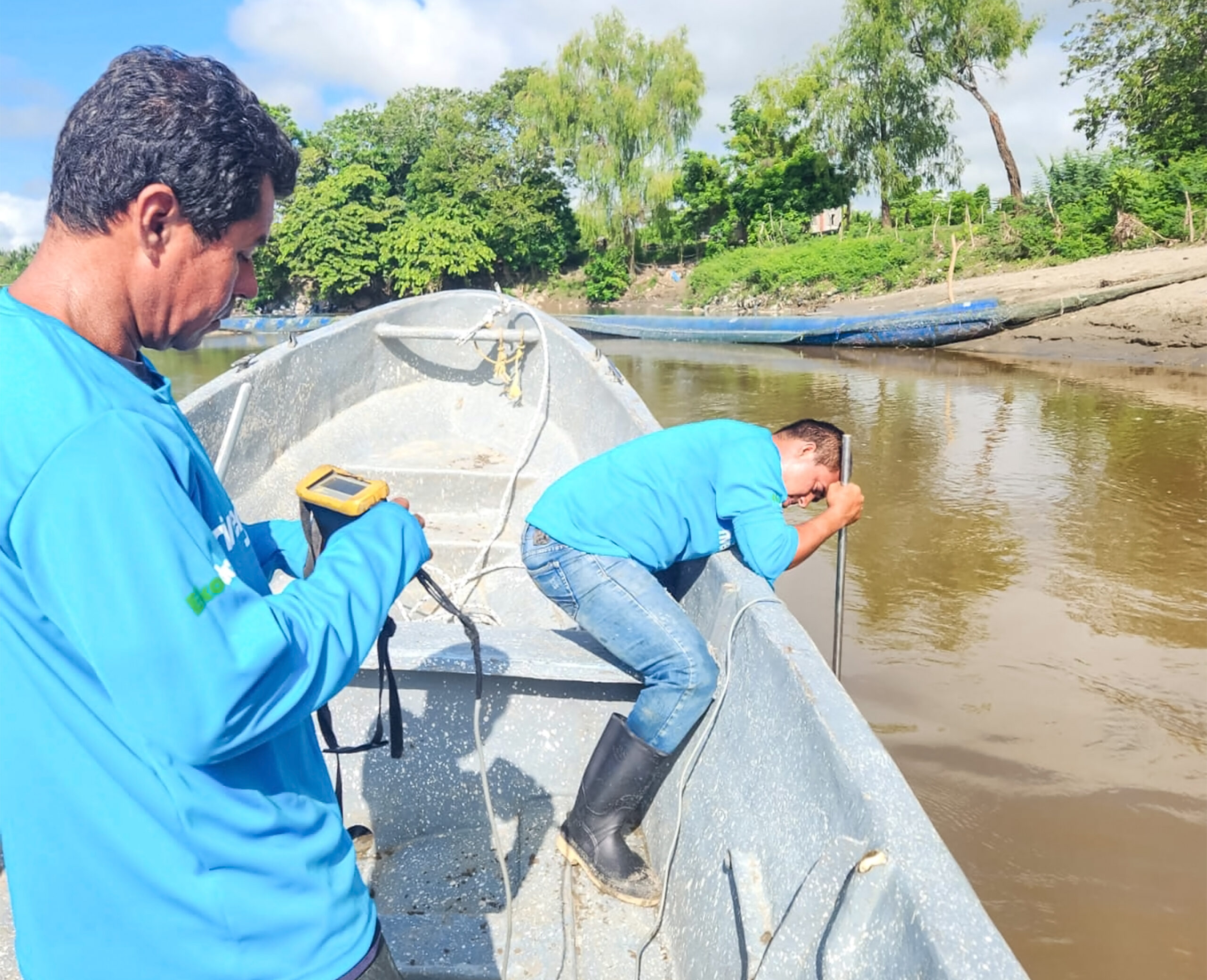 Technicians performing water monitoring measurements in the Motagua River from a boat